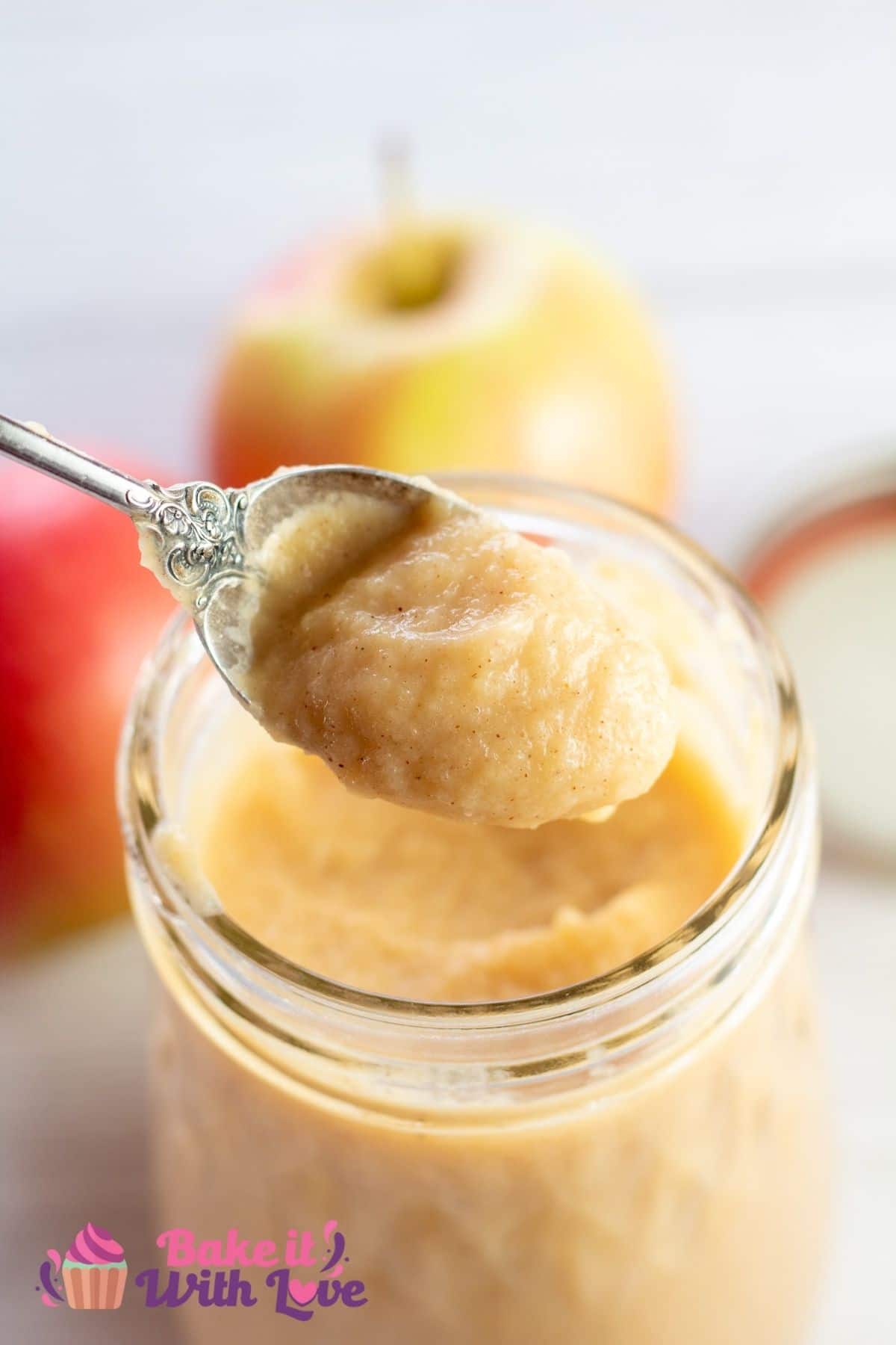Tall image of the apple curd being spooned from jar.