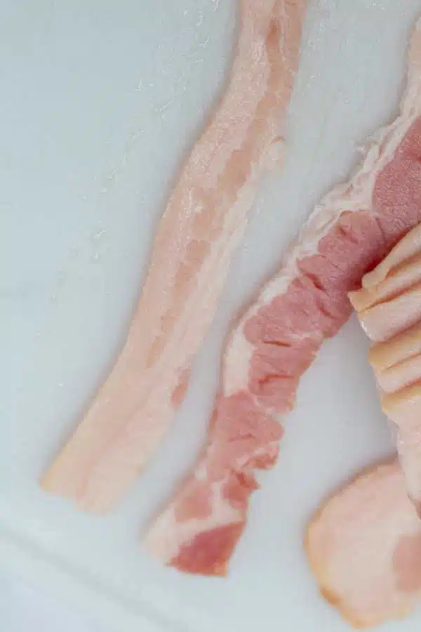 Process photo 2 continue slicing bacon strips.
