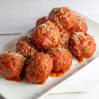 Best baked Italian meatballs sauced and plated on serving tray.