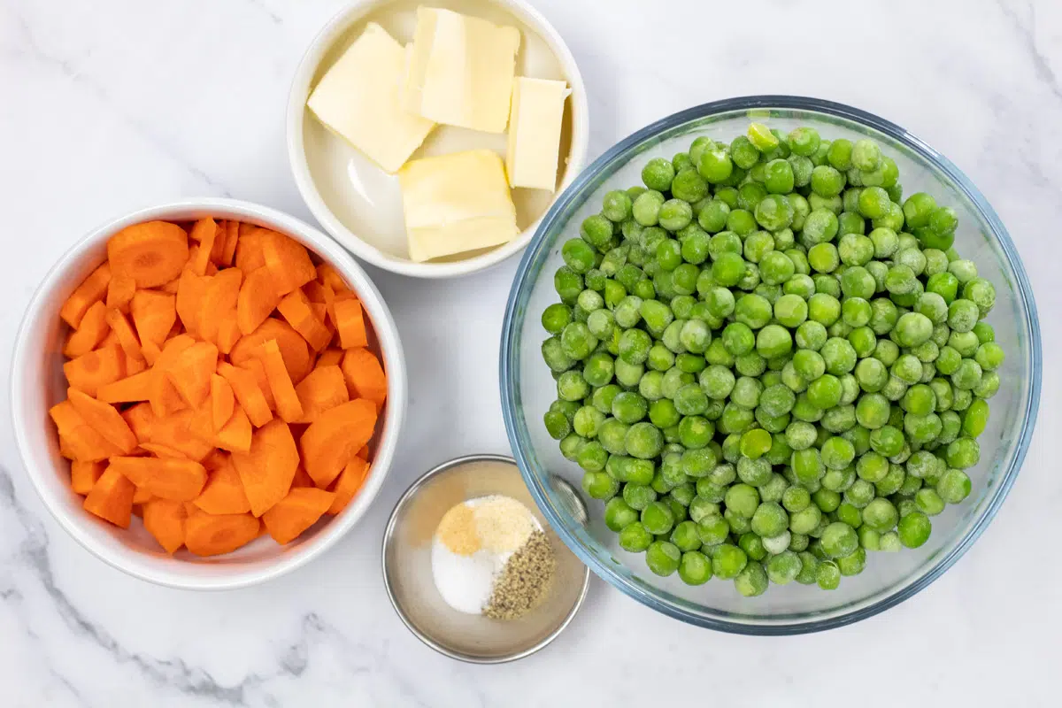 Overhead photo of ingredients needed to make buttered peas and carrots.