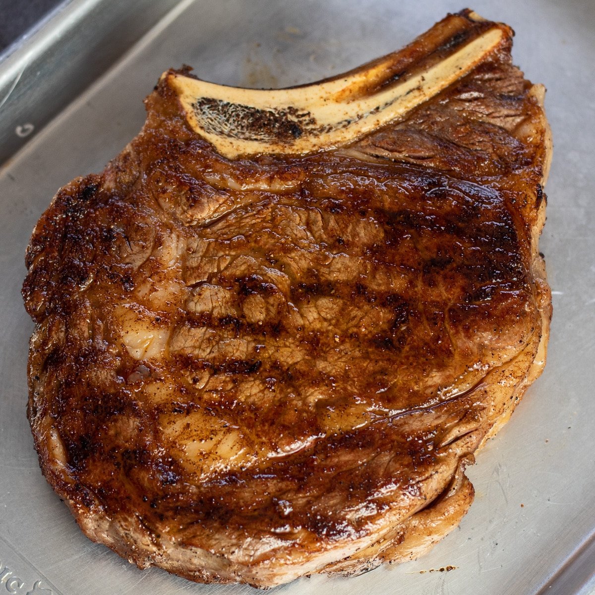 Square overhead of the perfectly grilled cowboy ribeye steak.
