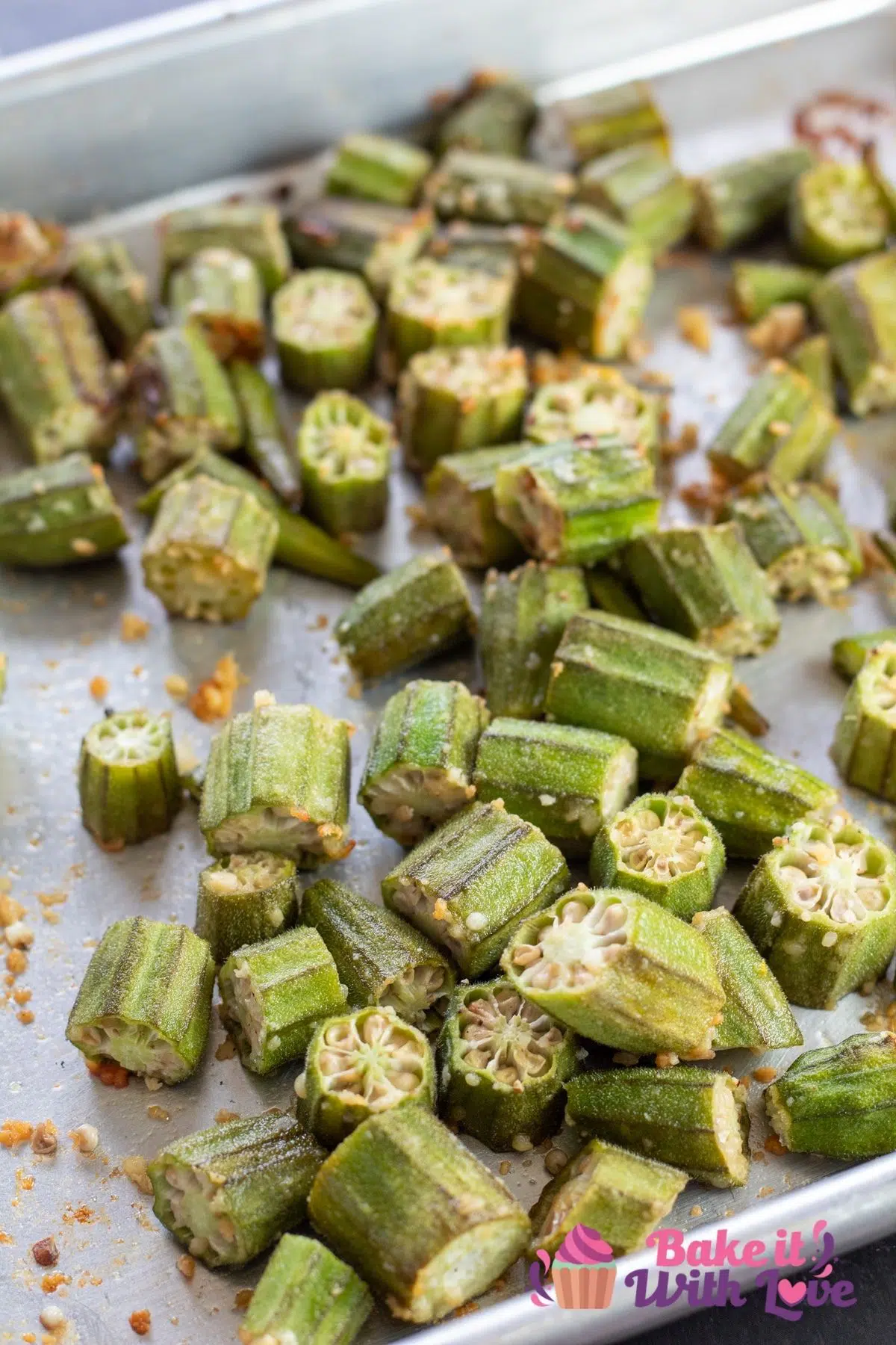 Tall section of the roasted okra on rimmed baking sheet.