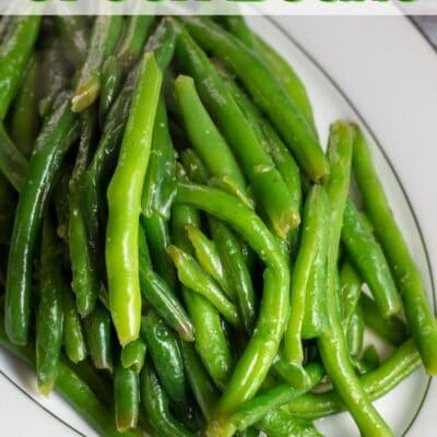 Pin image with text of sauteed green beans in a serving dish.