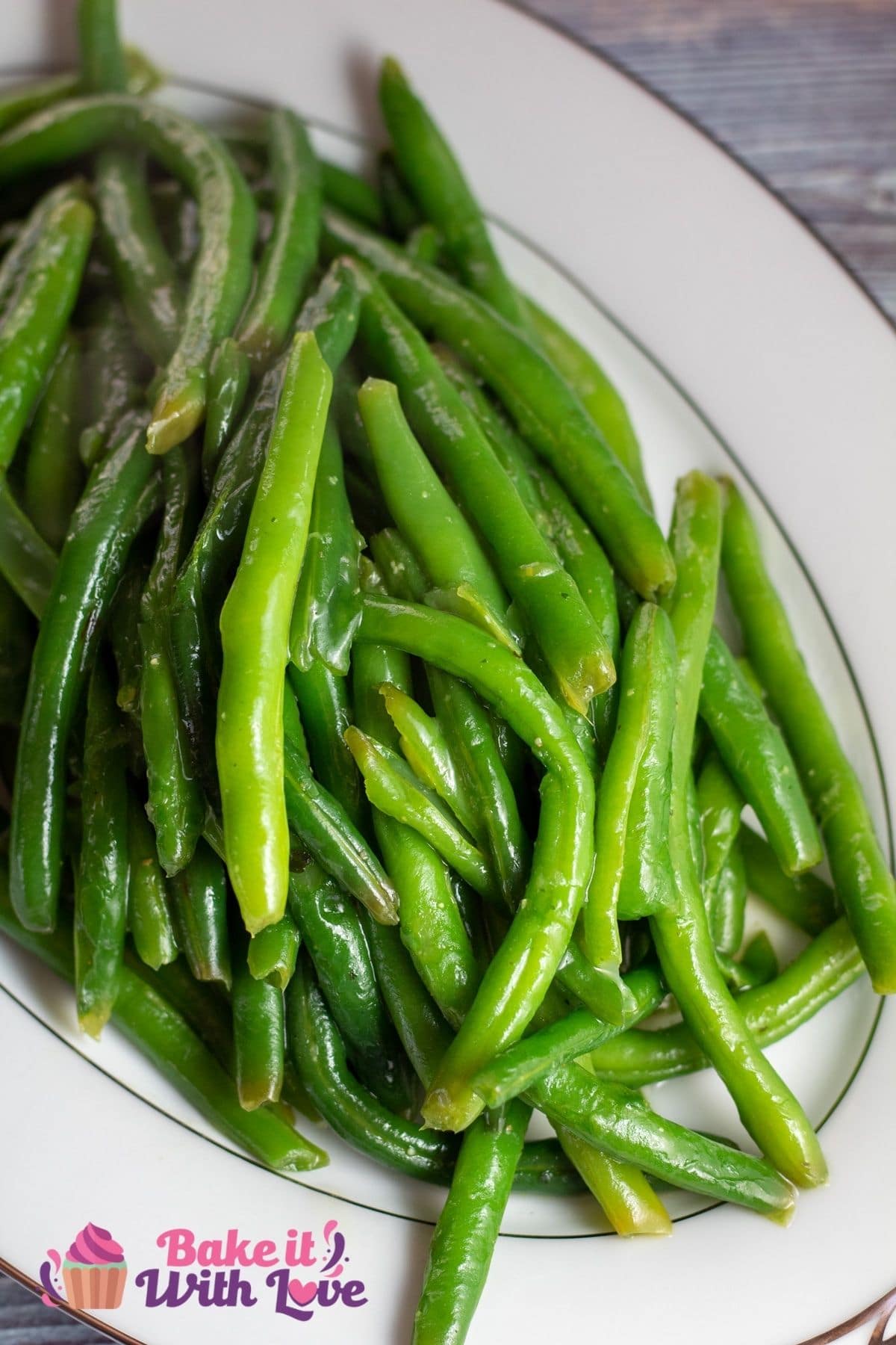 Tall image of sauteed green beans in a serving dish.