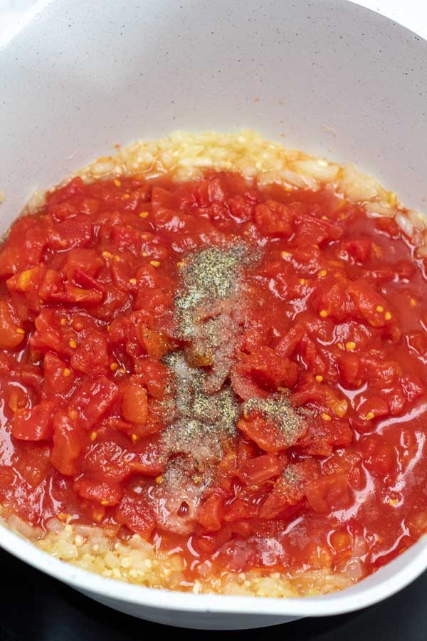 Process photo 3 showing tomatoes and seasoning added.
