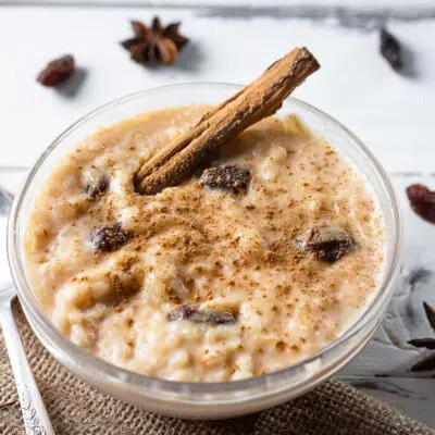 Best arroz con dulce rice pudding in a glass bowl with raisins and cinnamon.