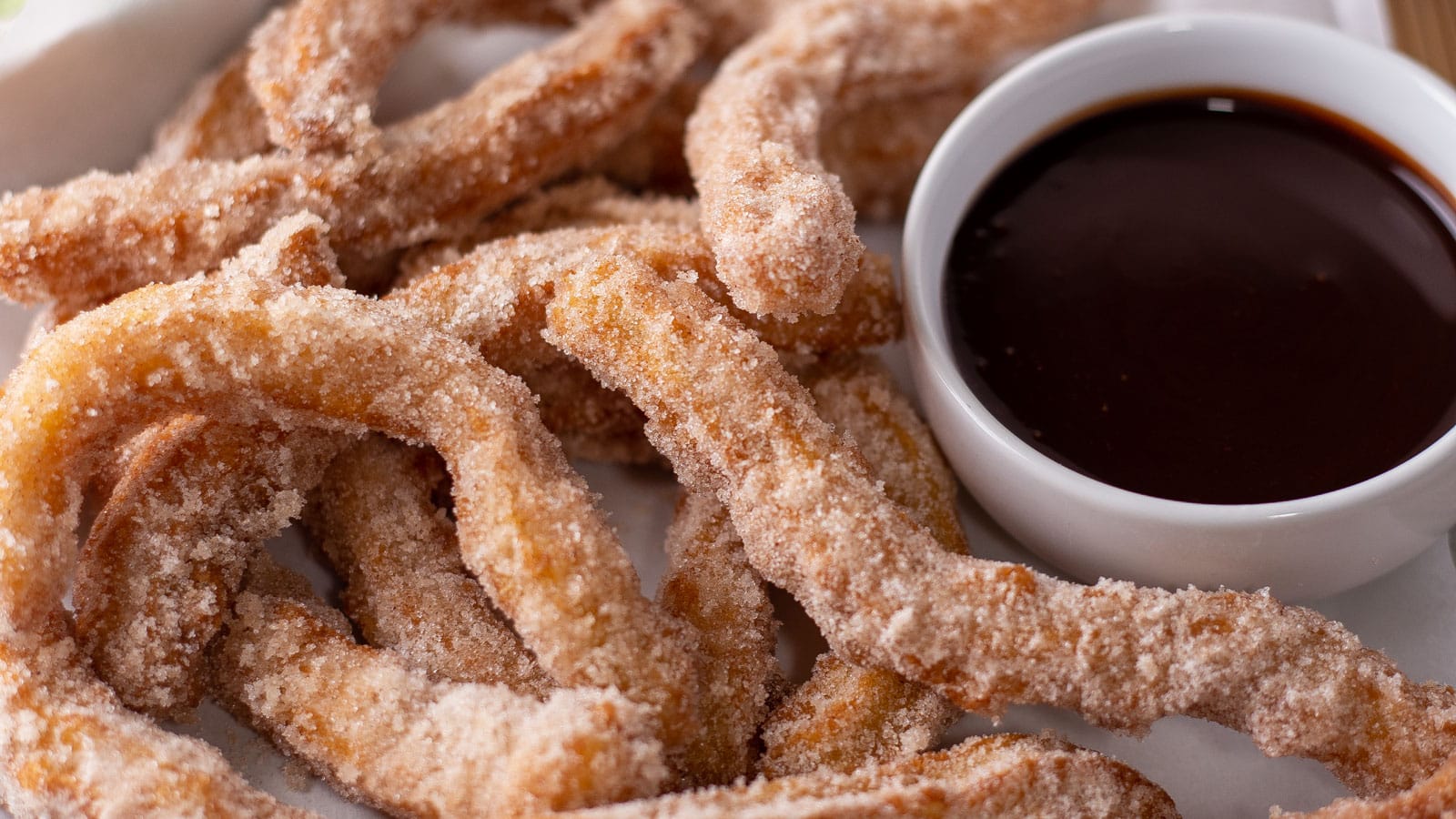 Homemade fried churros rolled in sugar and served with chocolate dipping sauce.