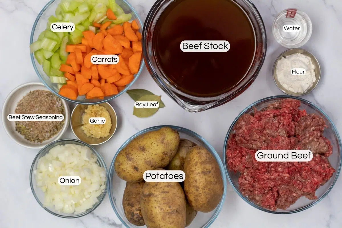 Overhead photo showing labeled ingredients needed for ground beef stew.