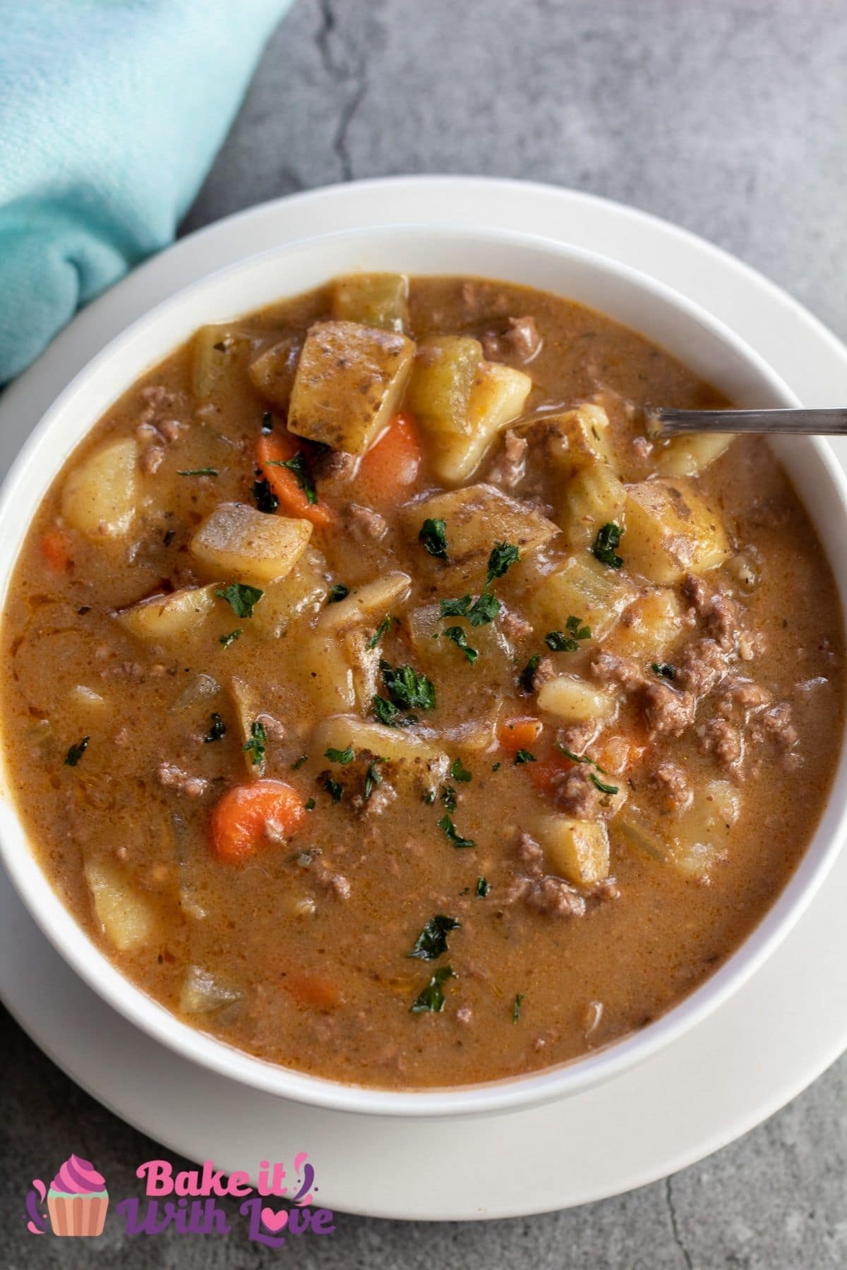Tall image of a white bowl of ground beef stew.