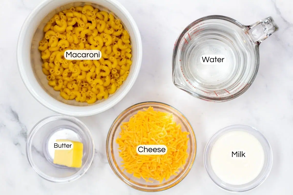 Overhead photo showing labeled ingredients for microwave mac and cheese.