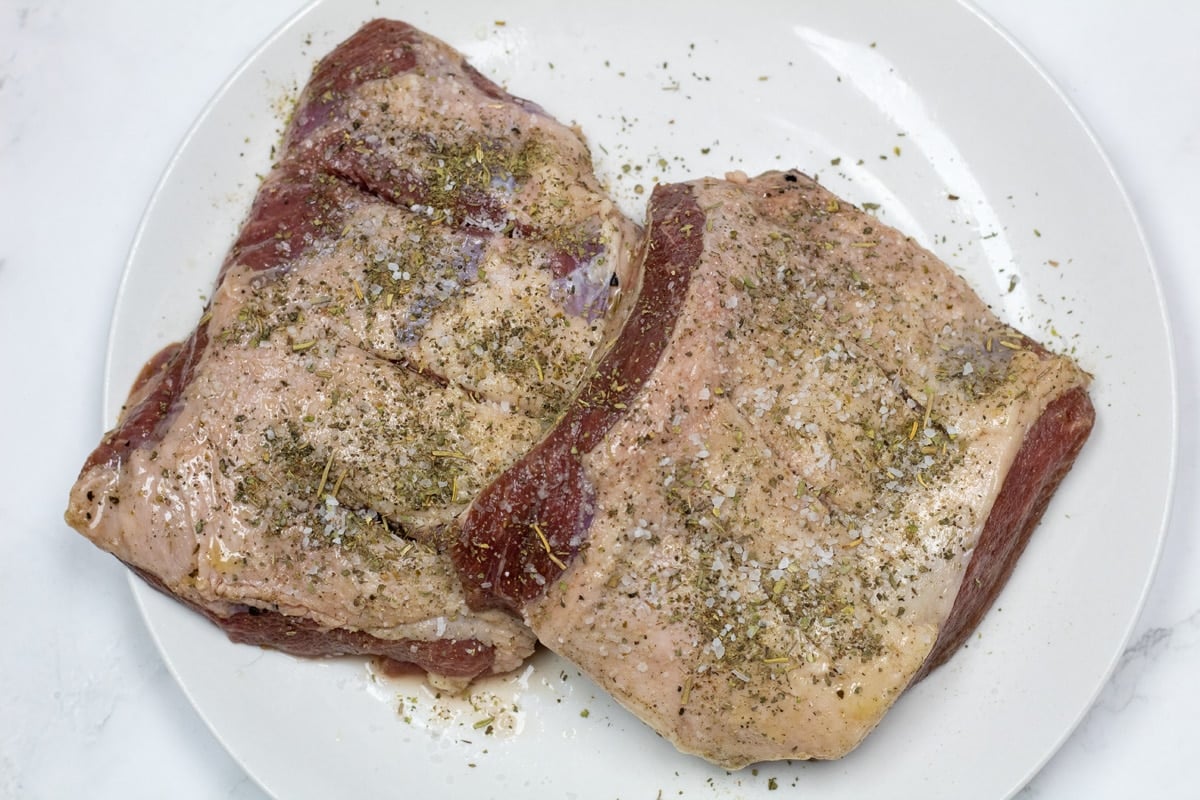 Pan seared lamb leg steak ingredients including lamb seasoned with lamb rub.