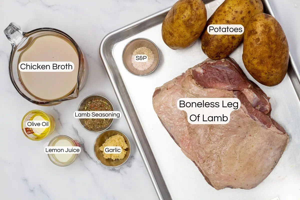 Overhead wide image of ingredients needed to make crockpot boneless leg of lamb.