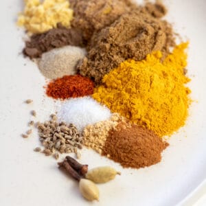 Measured out spices on matte off-white plate to combine and make my homemade yellow curry powder.