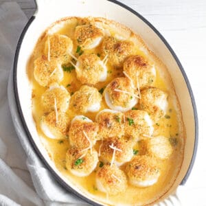 Best baked scallops topped with crumb topping in enamel coated cast iron baking dish.
