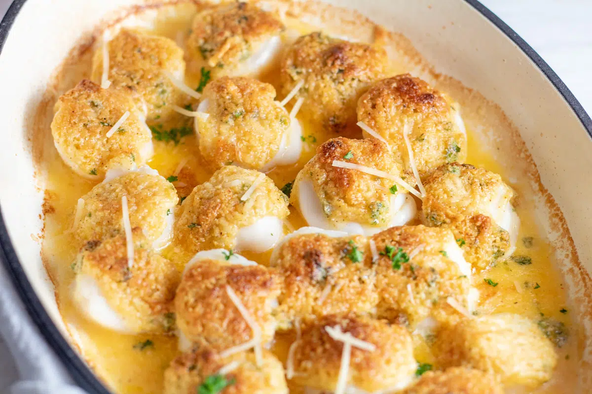 Tasty baked scallops with breadcrumb and Parmesan topping ready to serve.