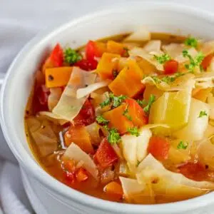 Closeup on the detox cabbage soup in white bowl.