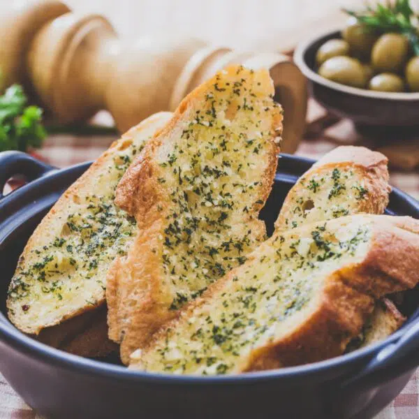 Square image of garlic bread sliced and ready to serve.