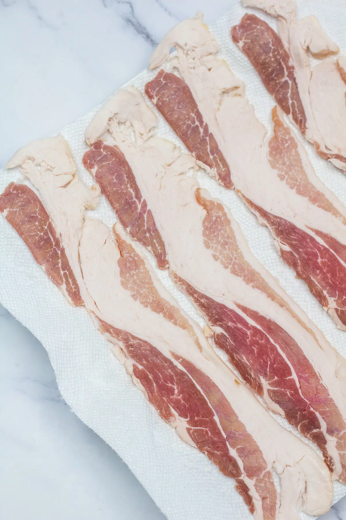 Process photo 1 of the thick-cut bacon slices arranged on plate.