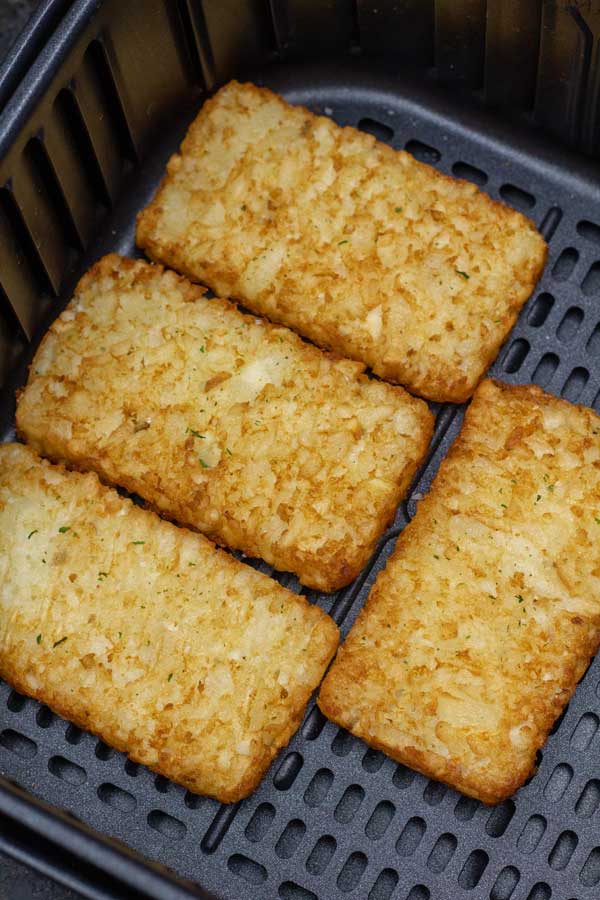 Process image 2 showing cooked hash browns in the air fryer basket.