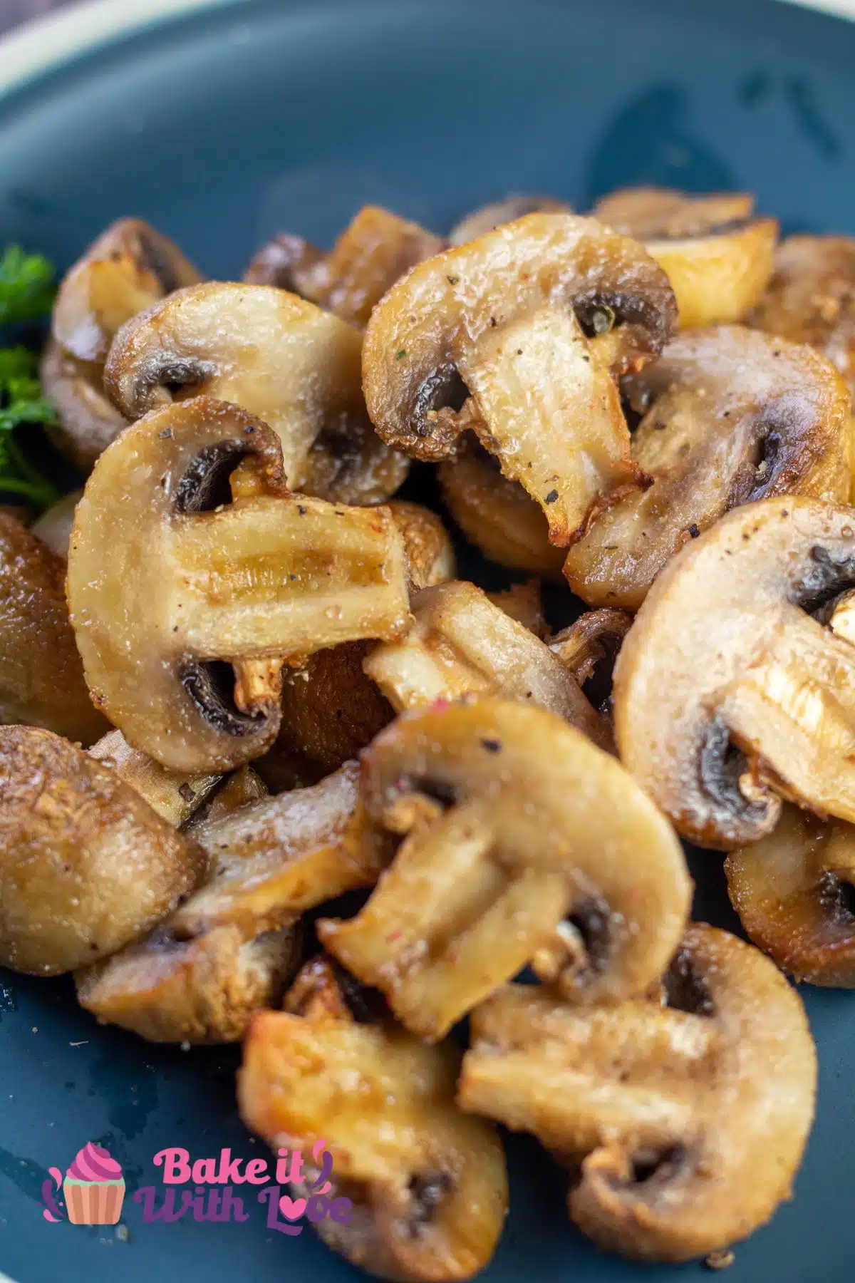 Tall image of air fryer mushrooms on a blue plate.