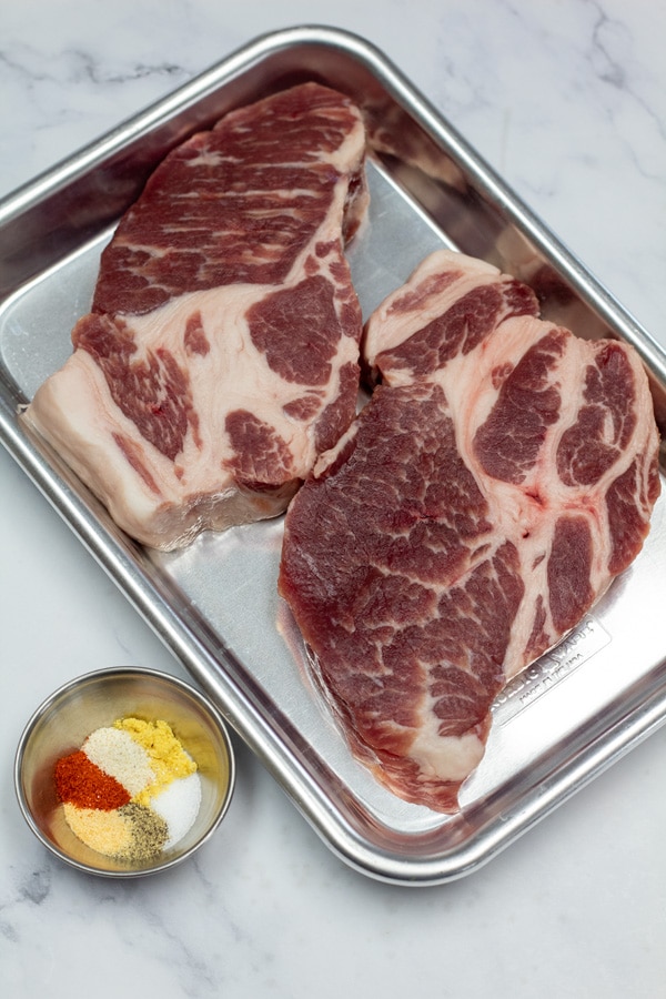 Ingredient photo 2 showing pork steaks and seasoning.