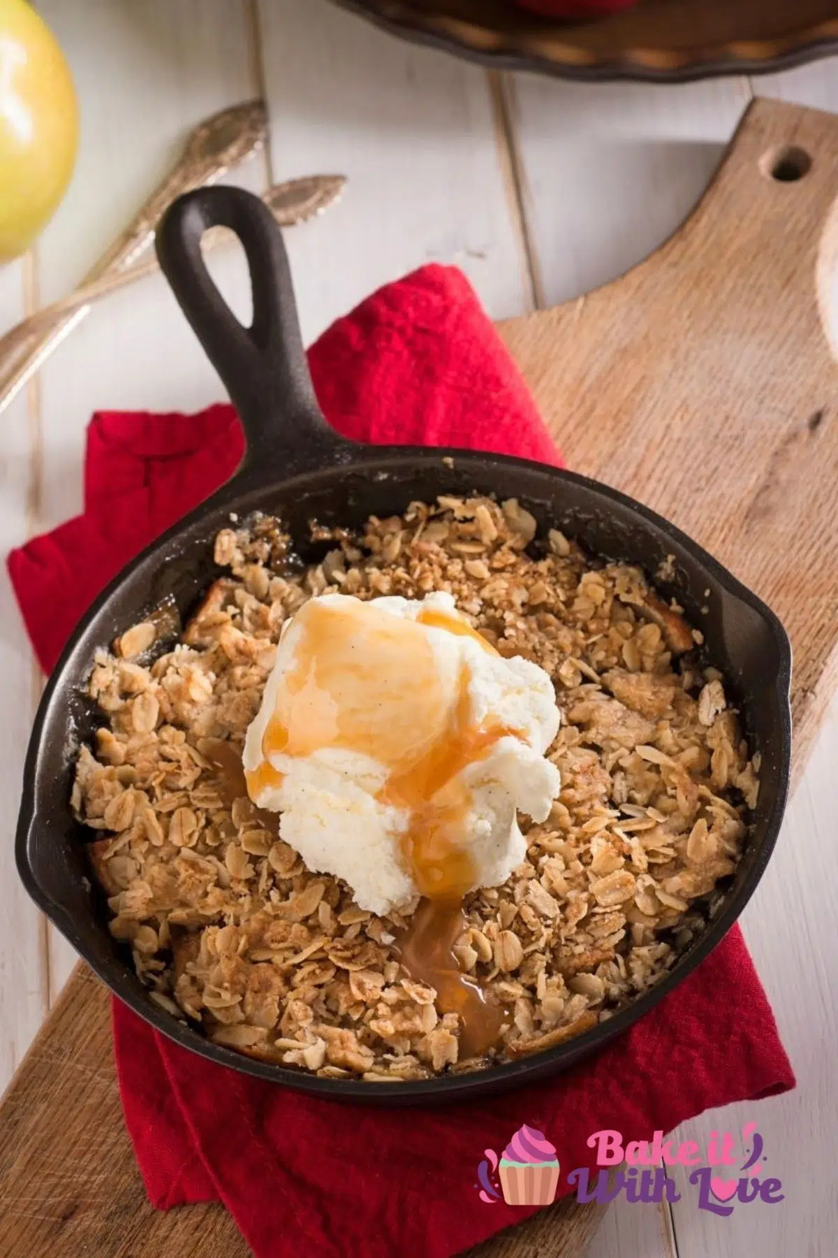 Tall image of apple crisp in a cast iron pan.