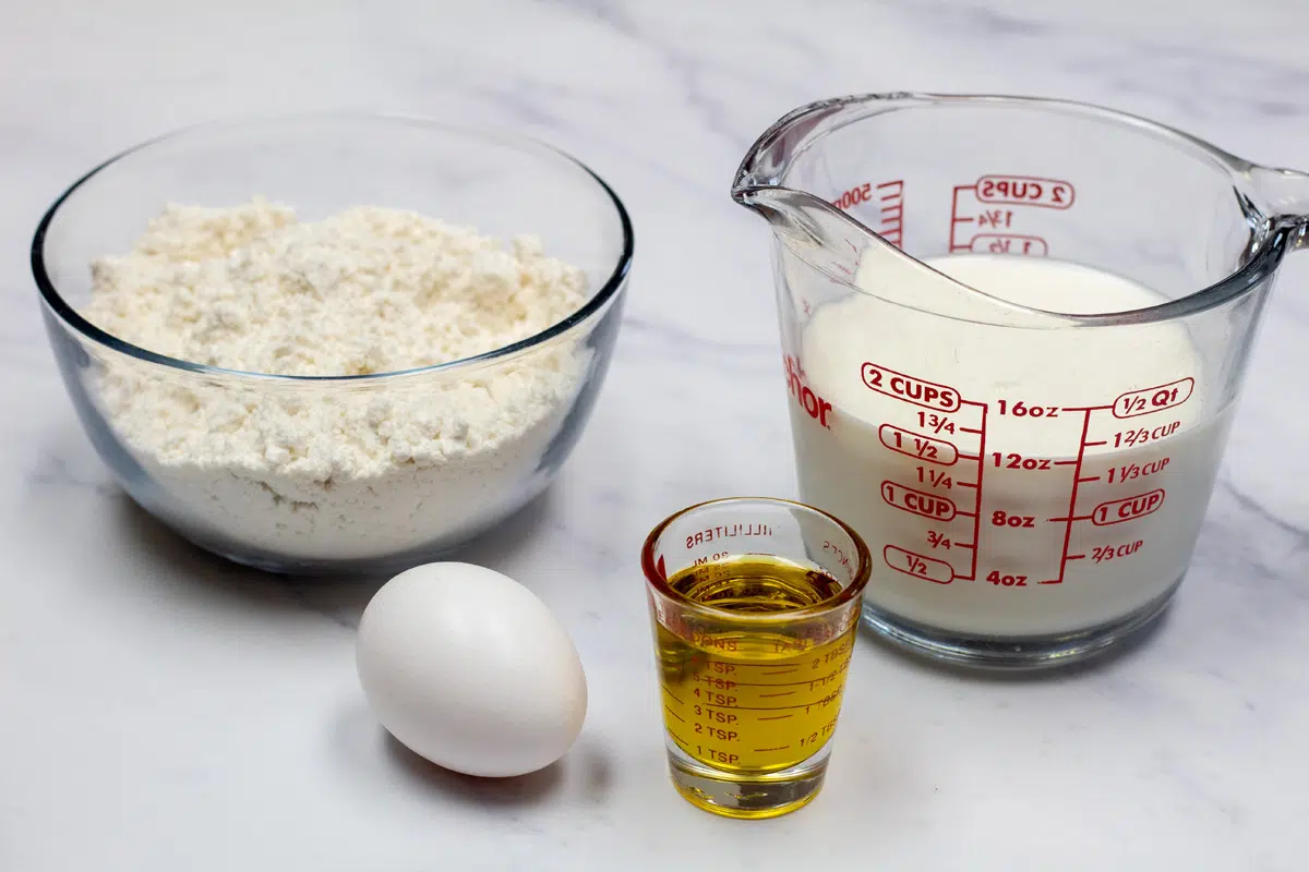 Wide photo of ingredients needed to make Bisquick waffles.