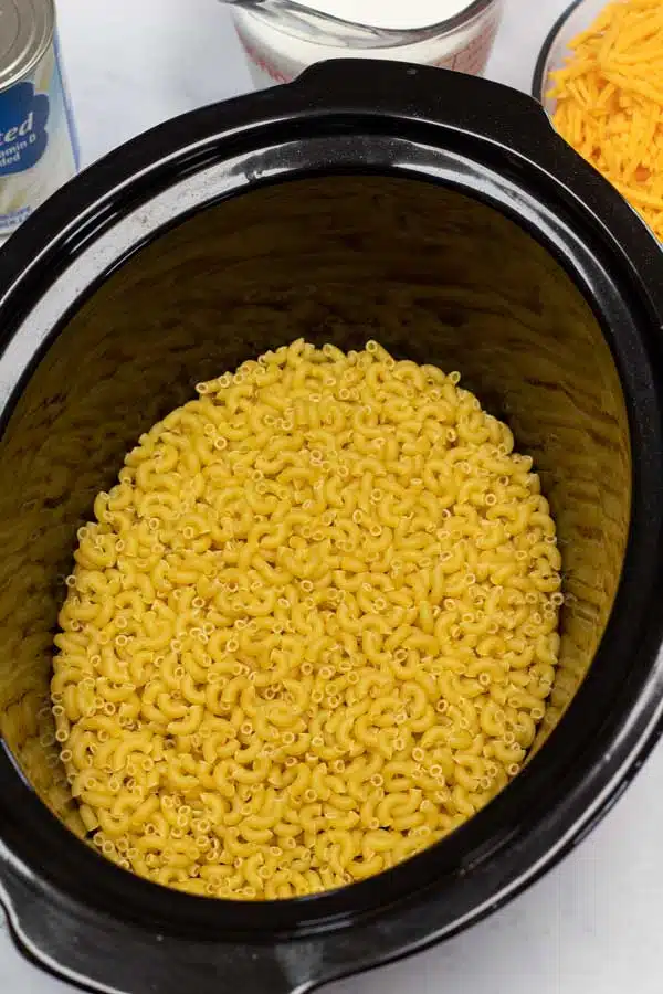 Process photo 1 add uncooked rinsed macaroni pasta.