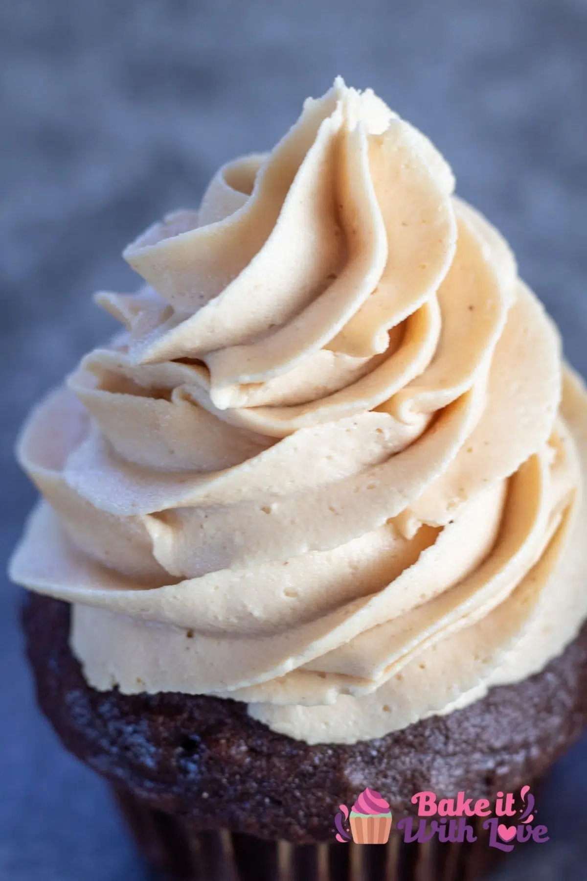 Tall image of peanut butter buttercream frosting on a cupcake.