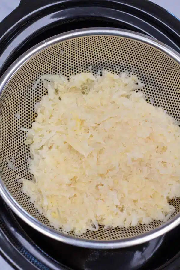 Process photo 2 straining the excess liquid from your sauerkraut.