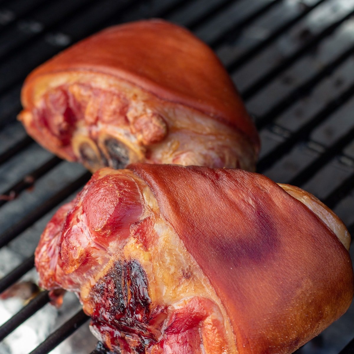 Simply smoked ham hocks shown on the smoker.
