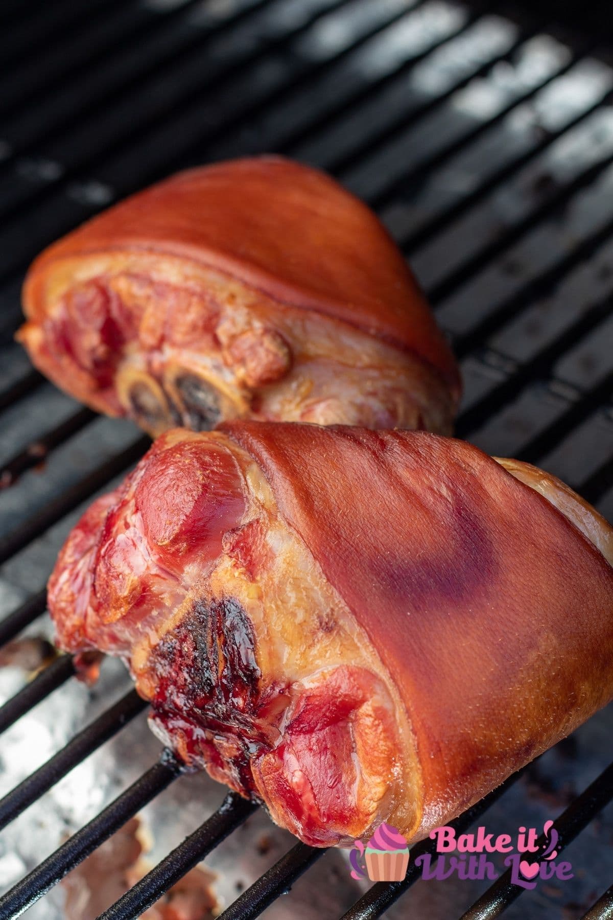 Tall view of the smoked ham hocks on the Traeger grill during smoking.