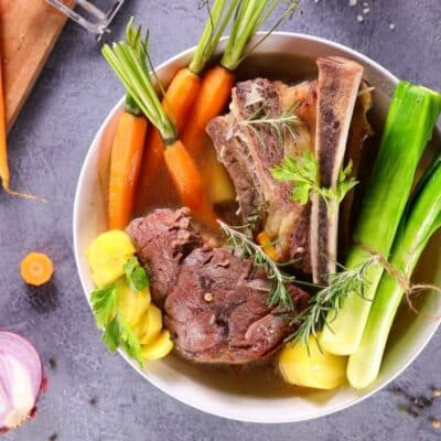 Best beef broth substitutes with all the basics of making a great broth pictured on grey background.