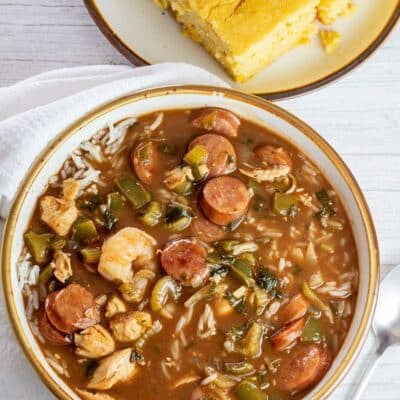 Cajun vs Creole illustrated with gumbo image in bowl.