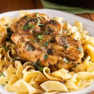 Best chicken marsala recipe closeup image on the dished entree served over egg noodles.
