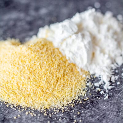 Corn meal vs corn starch in a visual side by side comparison on grey background.