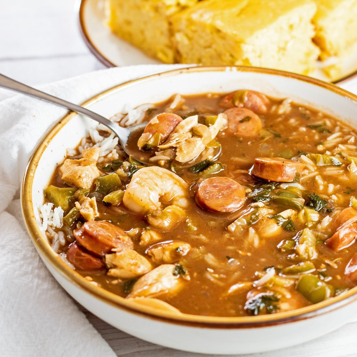 Amazingly flavorful gumbo soup combines the classic flavor of Creole gumbo with chicken, shrimp, and andouille sausage in a rich broth.