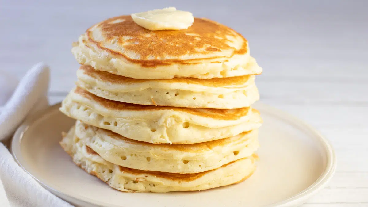 Wide view of the buttermilk pancakes on light background.