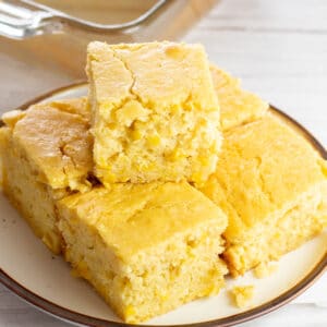 Closeup of the creamed corn cornbread sliced into squares and served.