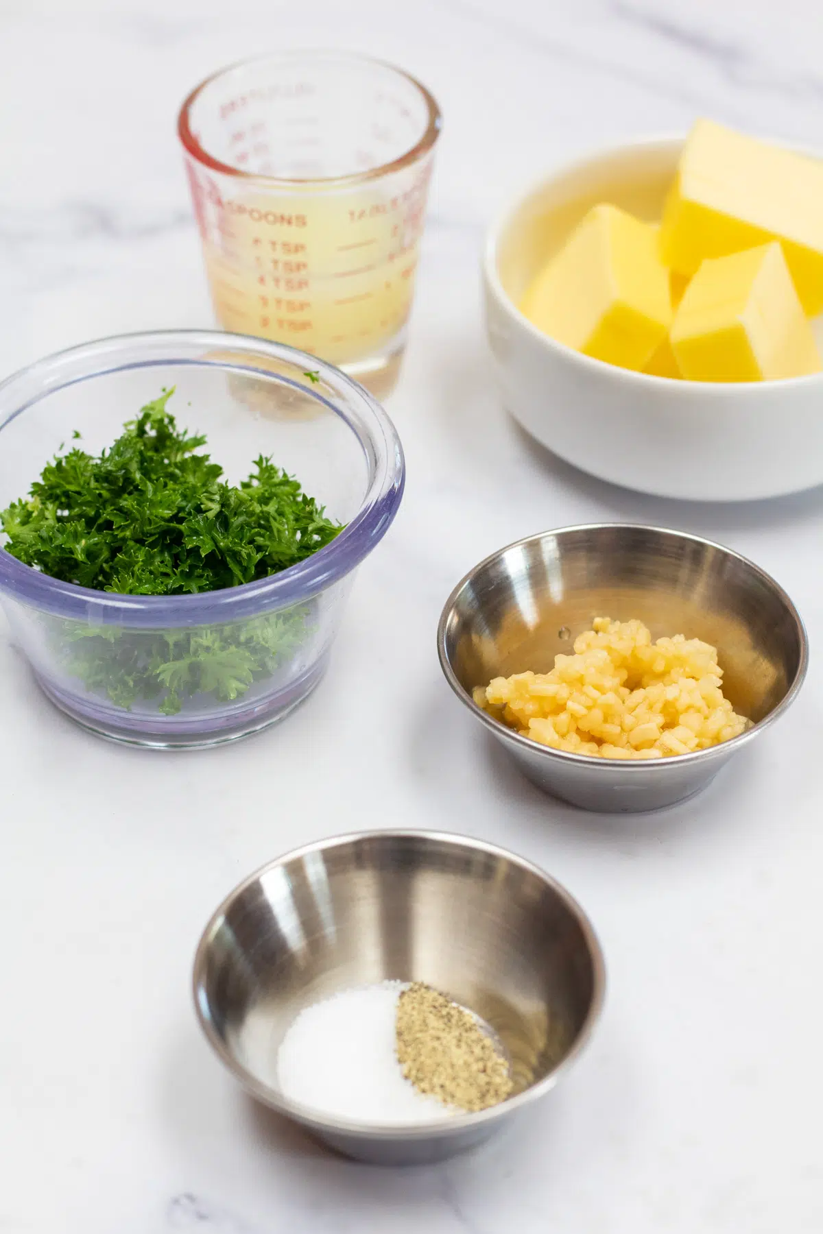Tall image showing ingredients needed for lemon butter sauce.