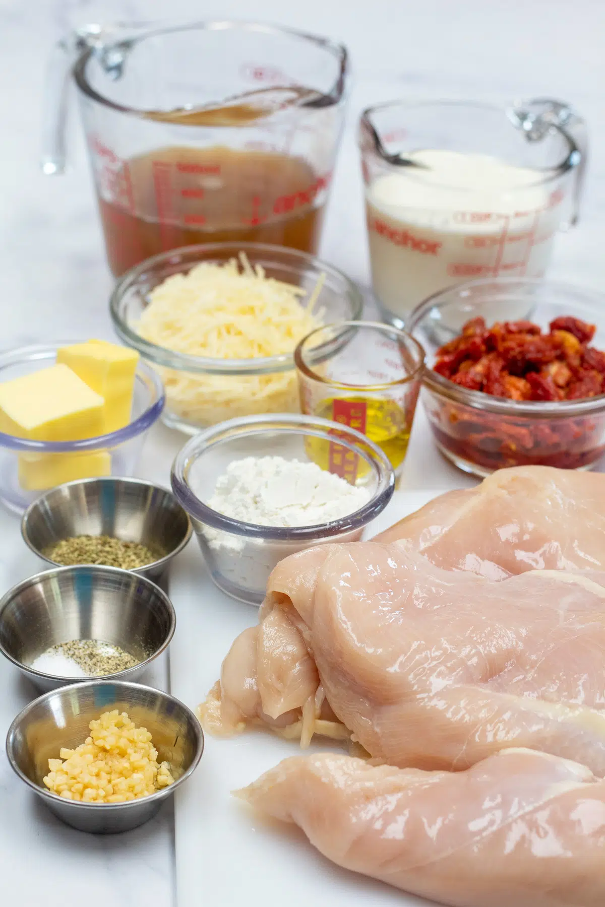 Tall image showing ingredients needed to make marry me chicken.