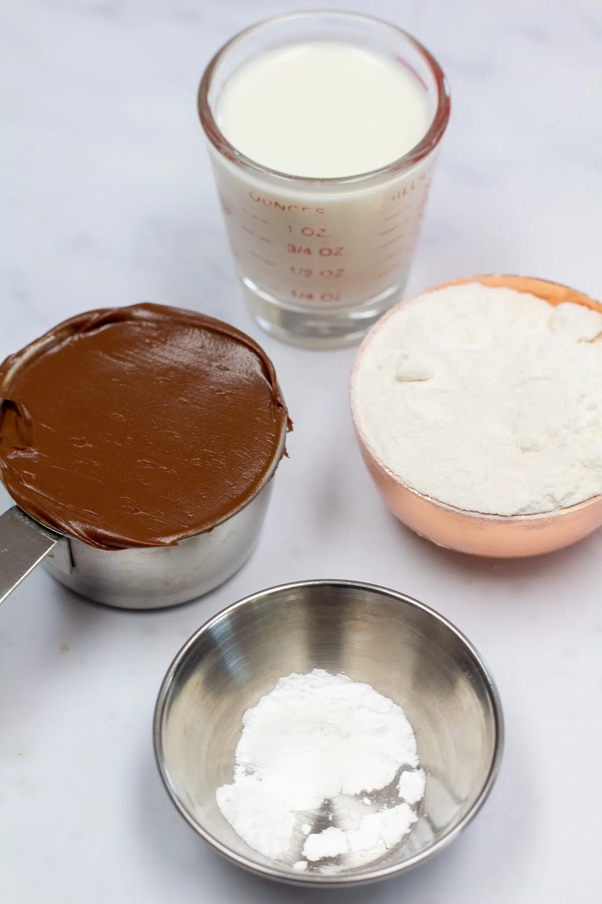 Ingredients needed to make a Nutella mug cake.