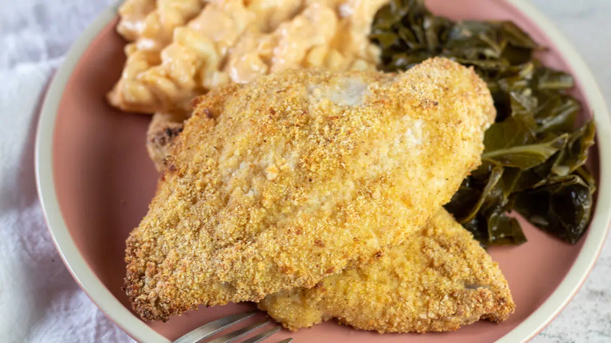 Wide overhead of the oven fried catfish with Southern sides, mac n cheese and collards.