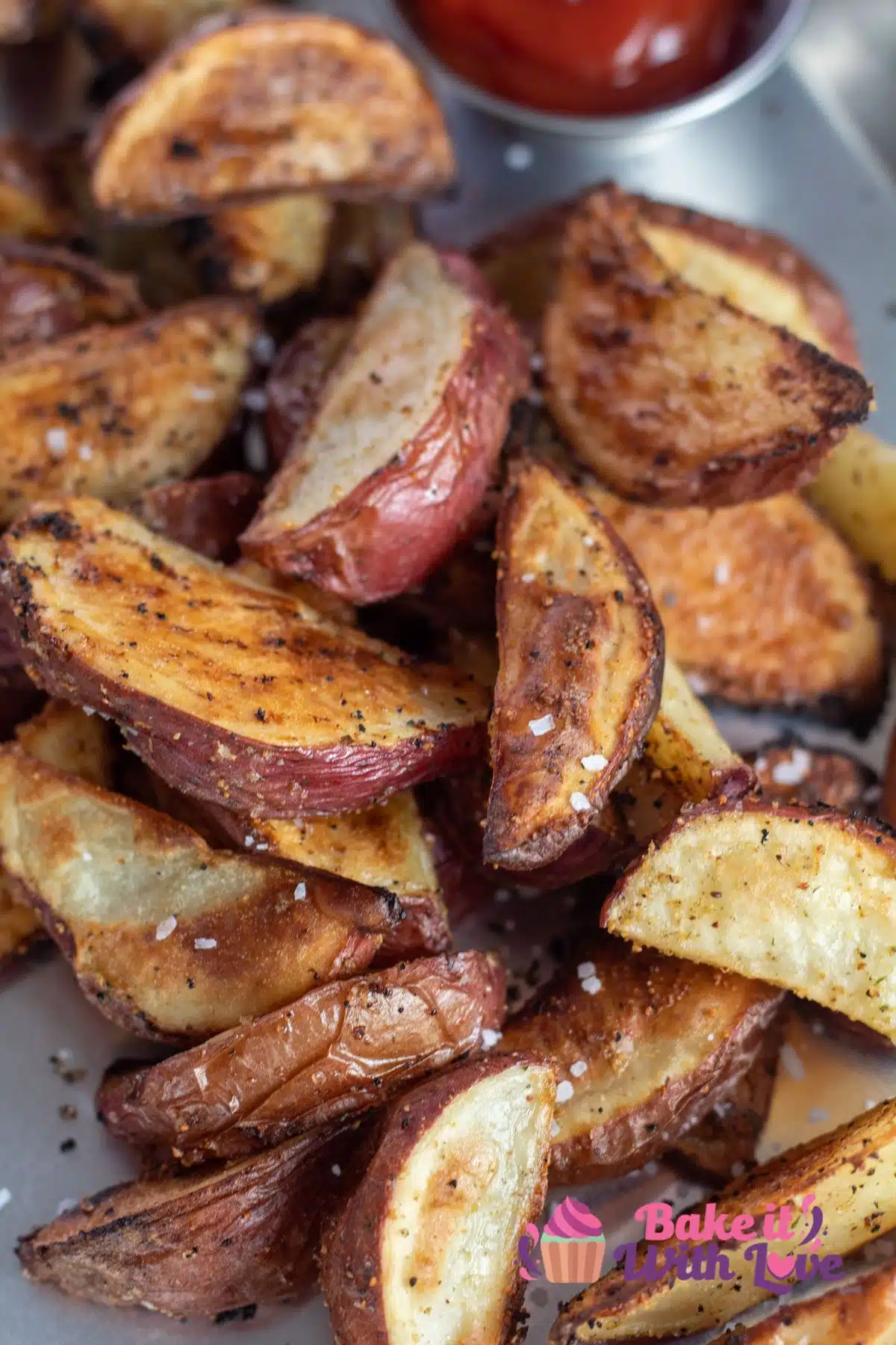 Tall image of roasted red potato wedges.