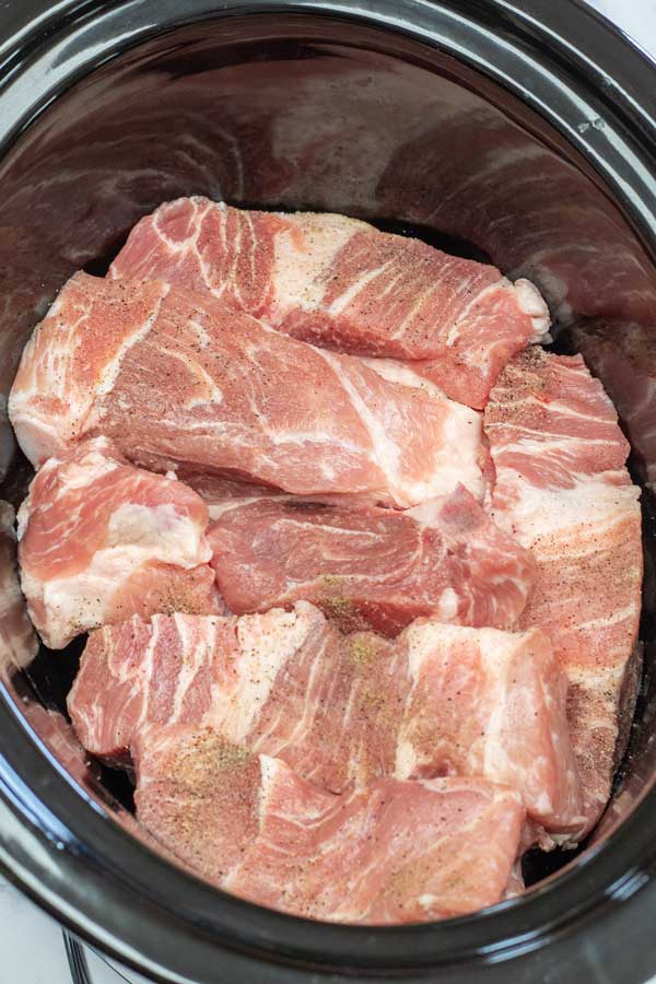 Process photo 1 add the country style pork ribs to your crockpot or slow cooker and season with salt & pepper.