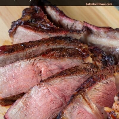 Pin image with text of sliced smoked tomahawk steak on a cutting board.