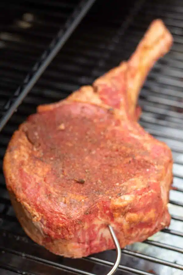 Process photo 2 showing tomahawk steak in smoker.