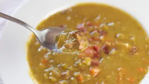 Wide image of split pea soup with smoked ham hocks.