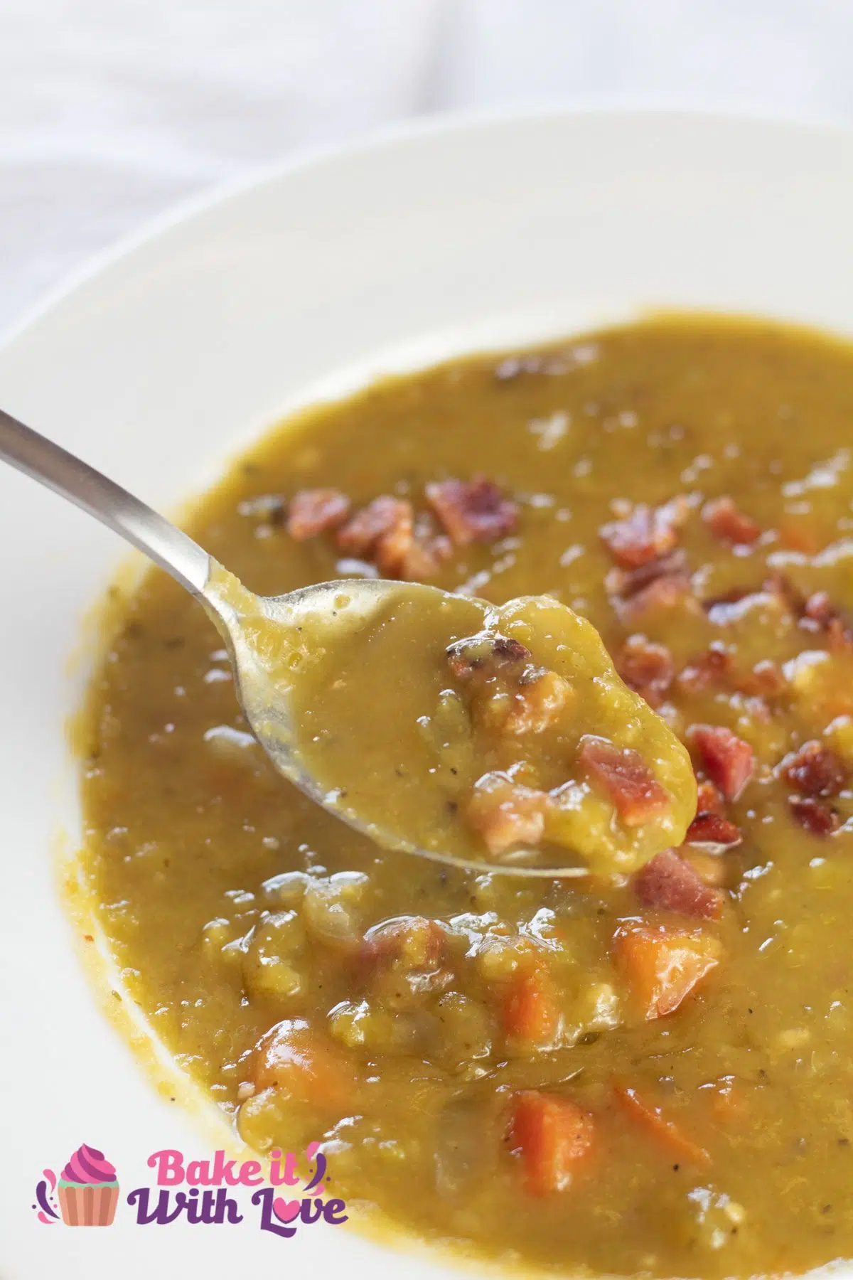 Tall image of split pea soup with smoked ham hocks.