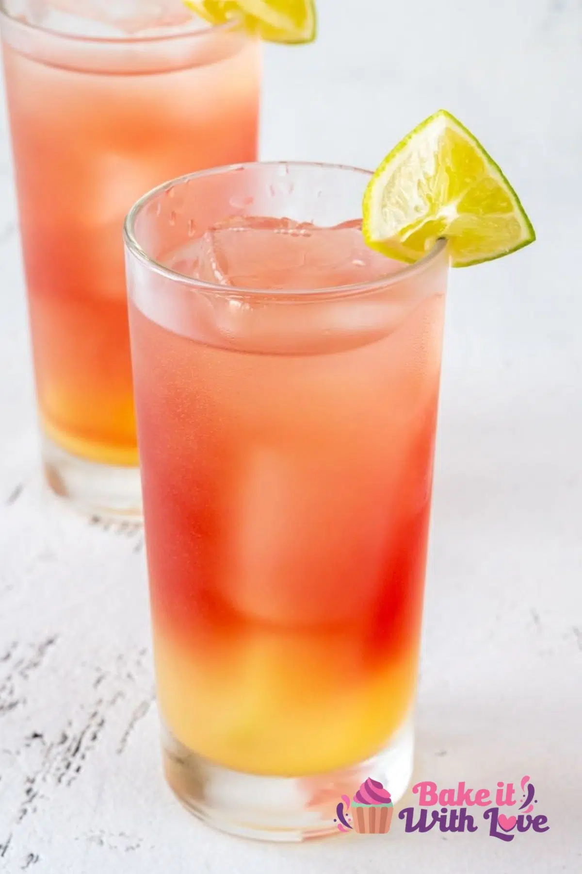 Tall image of bay breeze cocktails with lime wedge.
